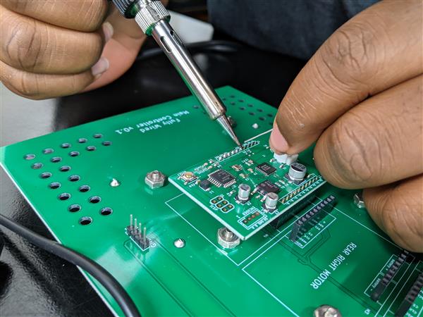 Student soldering microchip board